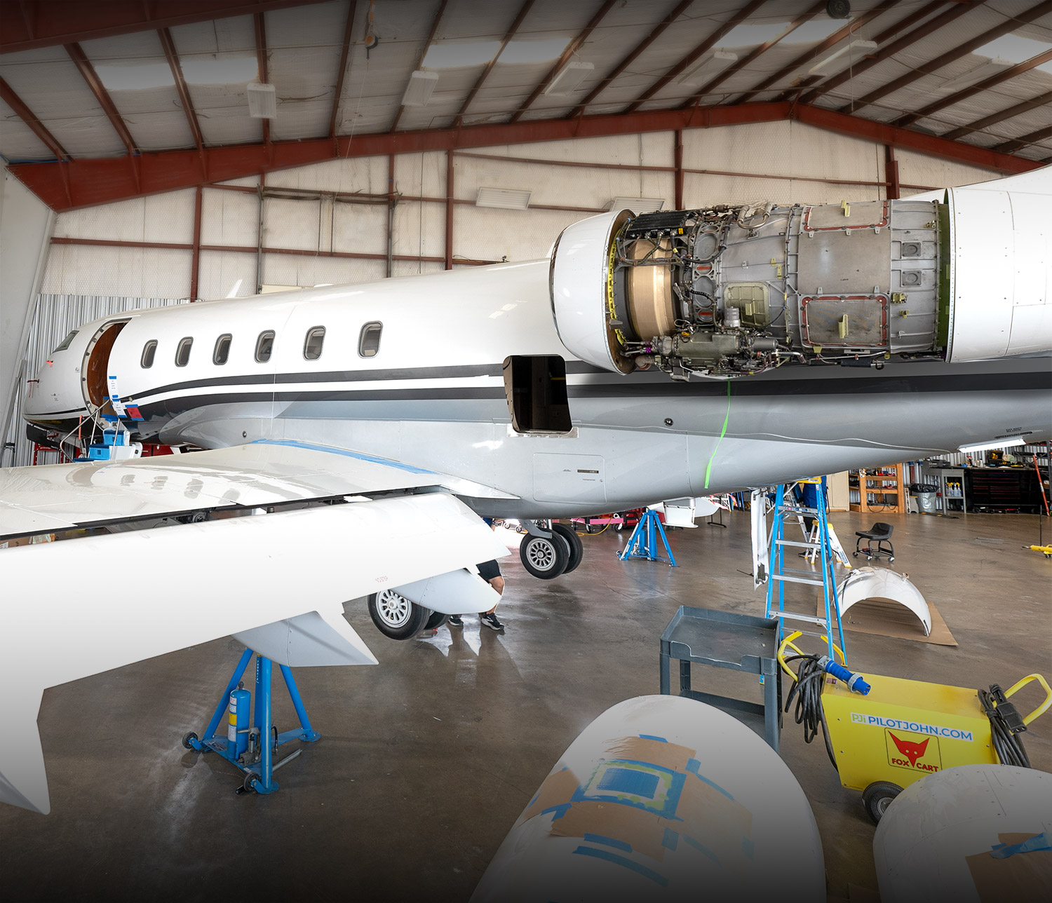 Bombardier Challenger on jacks in the Plane Place Aviation hangar during a scheduled inspection